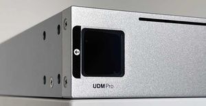 Photo of a Ubiquiti UDM-Pro. The small screen is off, and still has the original screen protector.